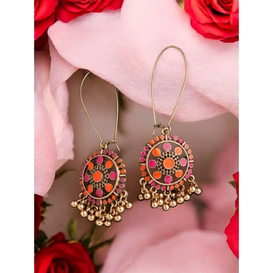 Boho antique gold dangler earrings with intricate orange and pink enamel detailing, finished with golden ghungroo drops, perfect for ethnic and fusion wear.
