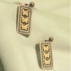 Elegant gold-plated butterfly earrings with a cutout design and crystal accents, perfect for adding a delicate charm to any outfit